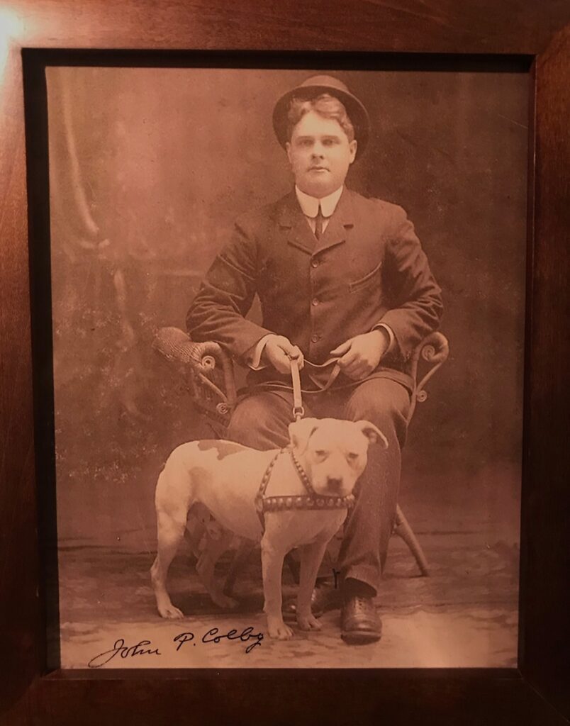A man sitting in a chair with his dog.